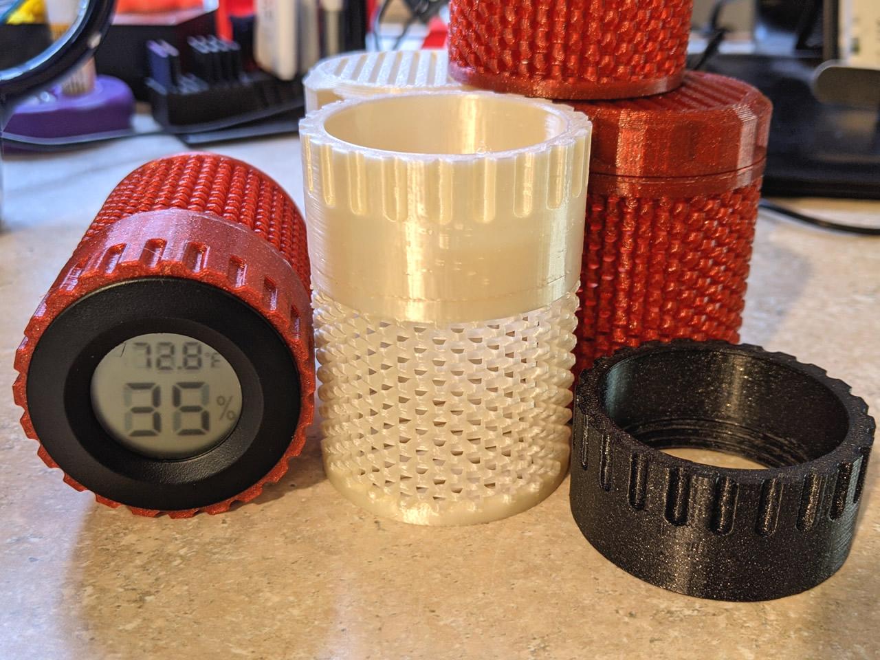 Fast Print In-Spool Silica Gel (Desiccant) Container with Hygrometer - Here you can see three different types of filament used: red (PETG), white (Silk PLA), black (Prusament Galaxy Black PLA). - 3d model