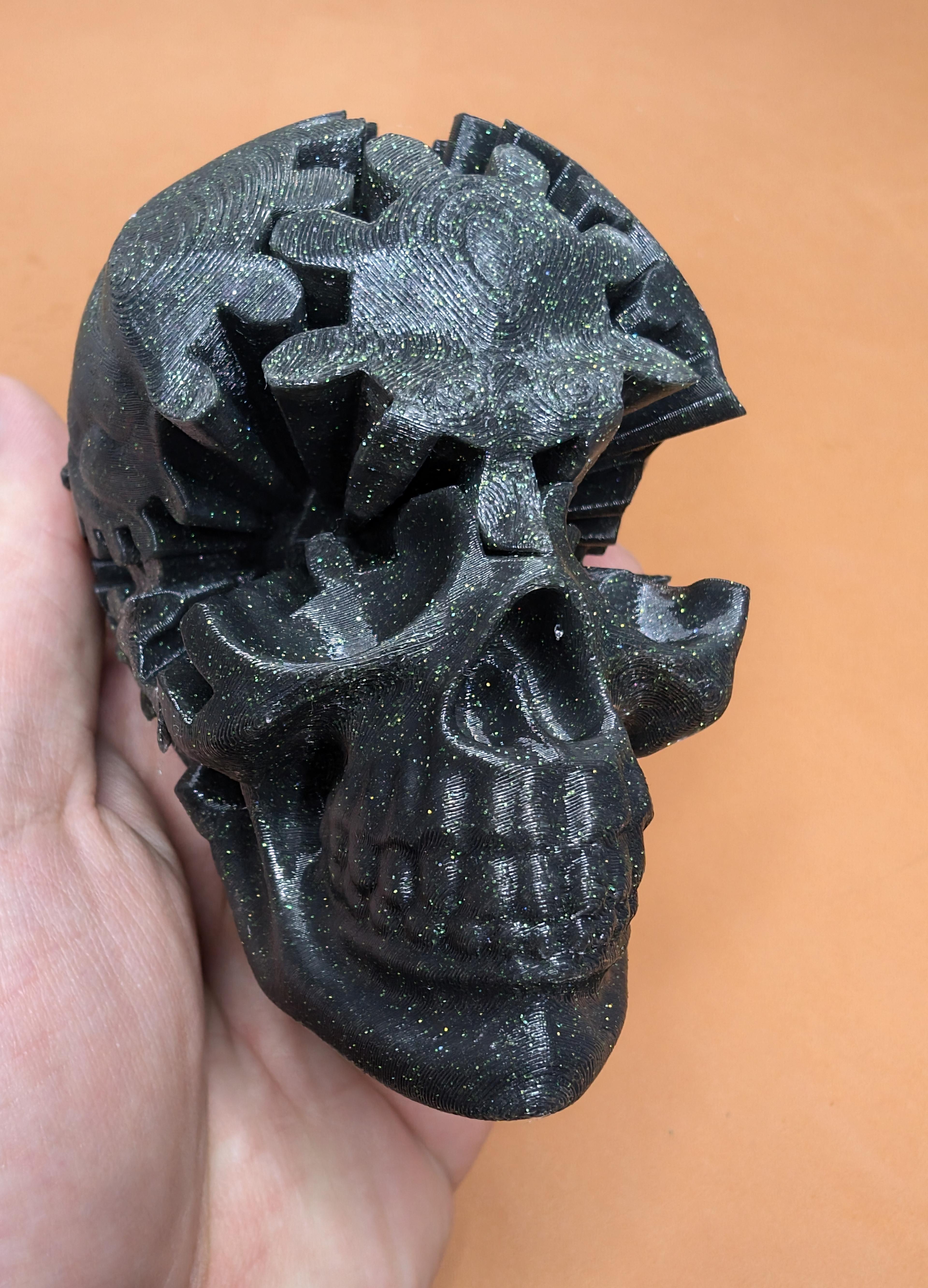 Gear Skull - Super cool print! I used a black with glow in the dark glitter filament from Yousu. This one was pretty tricky to assemble but once you get everything aligned properly it works great! I recommend printing some extra connectors. Looks super cool glowing in the dark!  - 3d model