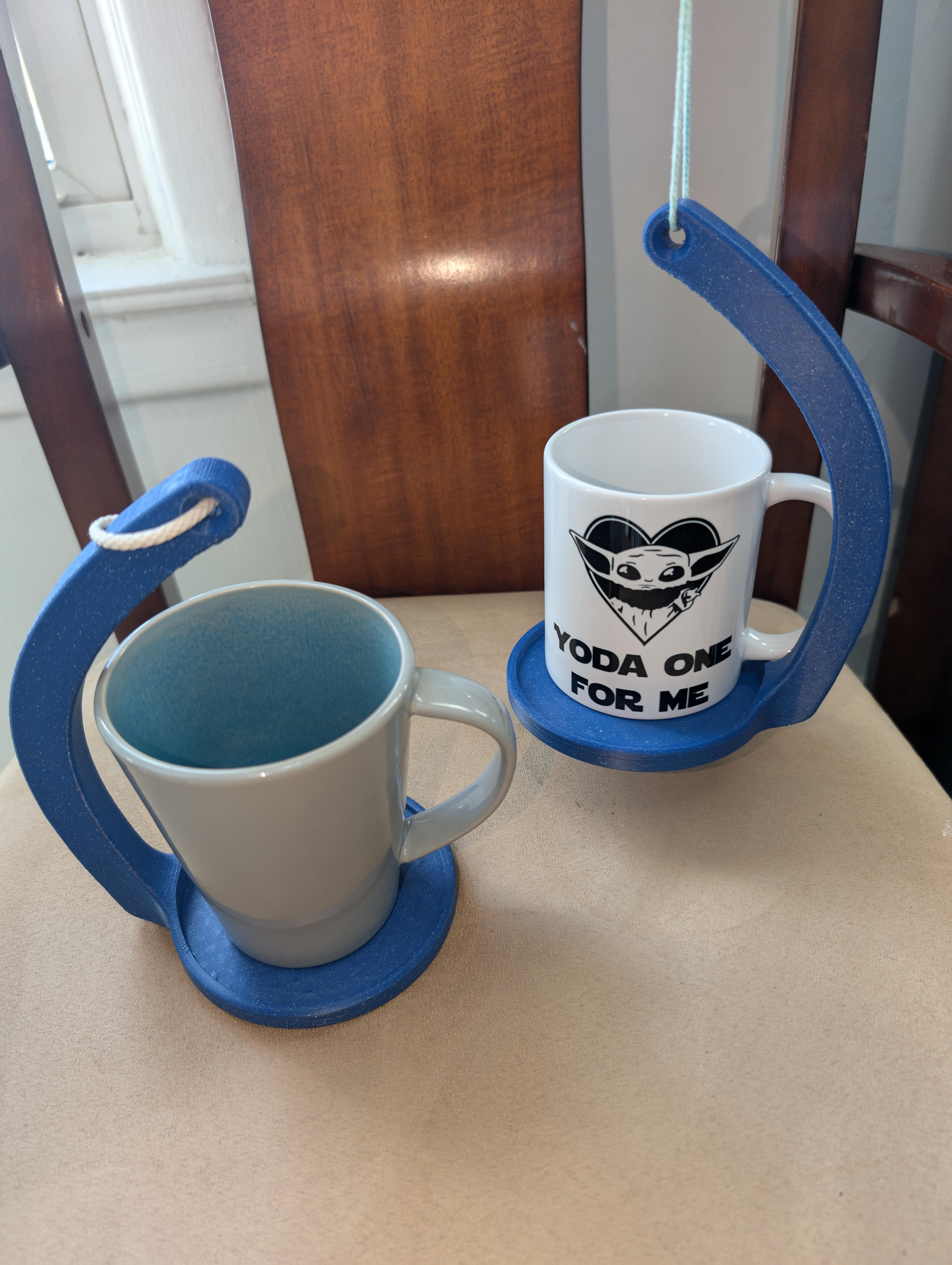 No-Spill Mug Holder - Printed using ASA just because I wanted it to hold up against the steam coming off of tea/coffee without any issues. The physics on this are awesome! The holder on the right is being held up a couple inches above the chair in this picture. - 3d model