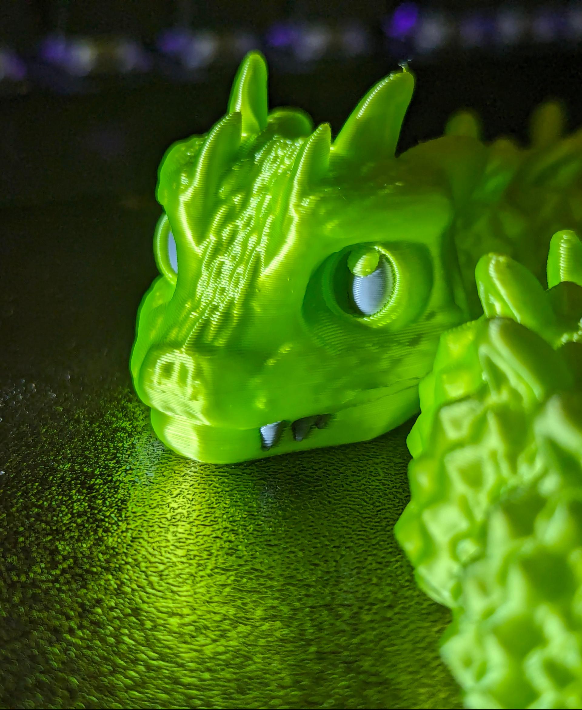 Baby Basilisk (Extra Long) - Articulated Snap-Flex Fidget (Medium Tightness Joints) - Printed on a Bambu Lab P1S, with Duramic 3D Silk PLA in neon green. Eyes and teeth are Duramic 3D PLA in smoke gray. - 3d model