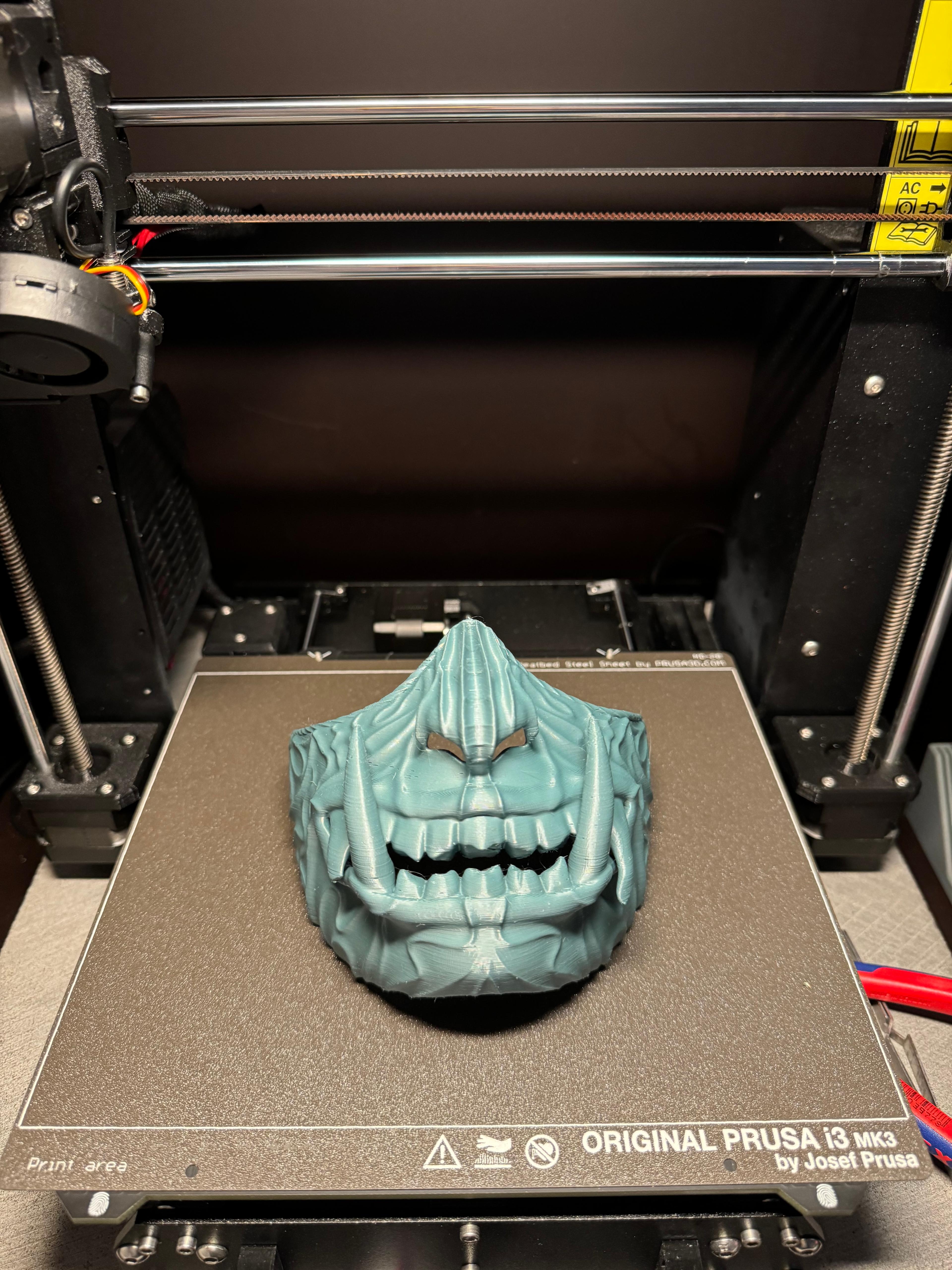 Oni Mask #1 - Did a scaled down version for my 5y/o son. Scaled to 87%, I measured his cheekbones left to right and scaled it manually on prusa slicer on the measuring net of the sheet. Was really easy. Settings on 0.2mm and 15% infill with organic supports. Removing supports on the inner teeth was a bit hard, but okay. Sanded the outline so he cannot hurt himself while playing.
Now he is playing ninja with Oni mask like in Ninjago. - 3d model