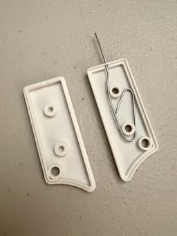 Awesome idea—exactly what I was looking for! Had a half-unfolded paperclip floating around my desk for those random device reset buttons, and I knew there had to be a print for this.
My Knipex cutters worked well for separating the pieces and trimming off the tab. I also cut a little notch out of the non-paperclip-holding side to make space for the paperclip where the pieces fit together, otherwise they wouldn't sit flush with each other.
M3 x 5mm screws worked fine. I had an M2.5 screw that seemed like it might also have fit, had that been my only choice. 3d model