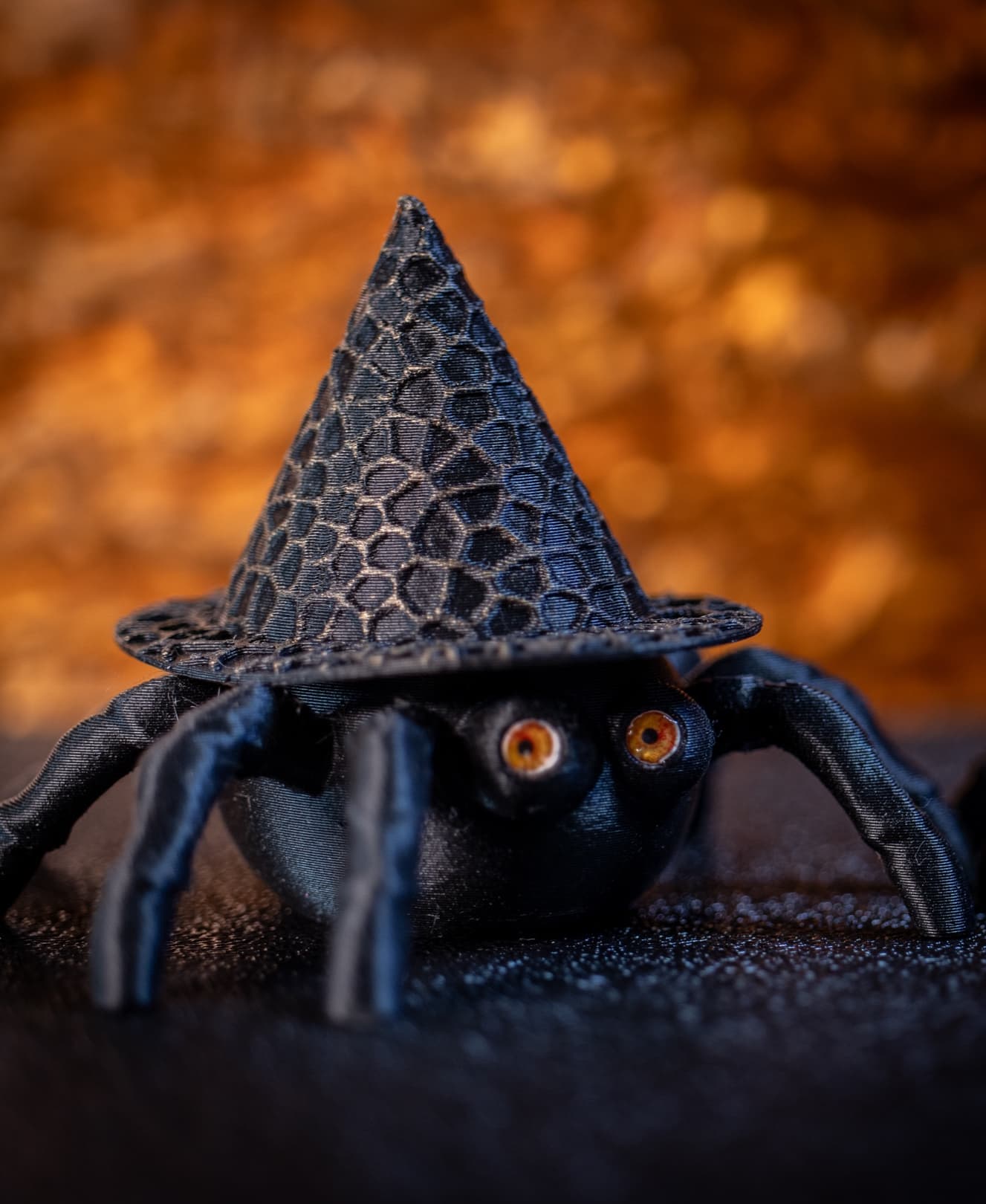 Thank you for such a fun design! I resized them to 3 inches, then printed the Spider Pot & Hat using Duramic Matte Black PLA. Then used some gold colored wax on my finger to rub on the high parts of his hat. Printed teeny eyes w/laser printer, then paper punched them out. Glued the eyes in w/3D clear craft glue. I made another one w/blue eyes. :-) Love them! Thanks so much.