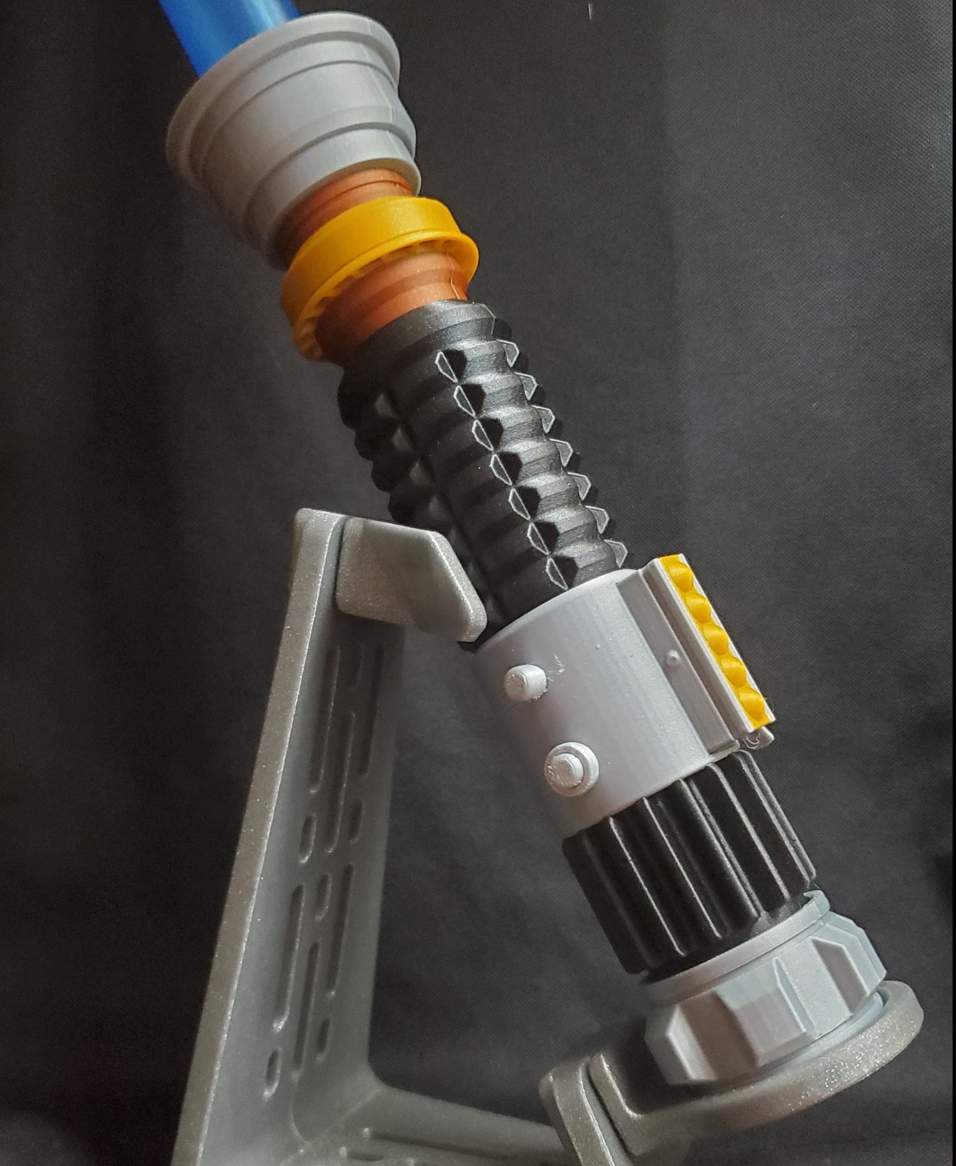 Saber is all polymaker metallics Silver, Gold, Bronze, Black. Blade is translucent blue and stand is glitter silver.