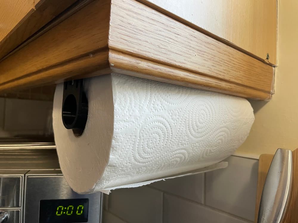 Fitted to the bottom of a kitchen cupboard, just screwed the bracket into the wood. Placed one against the front face and the other at the right distance for a loose hold and so it doesn't need to be bent too much to add/remove the kitchen roll.