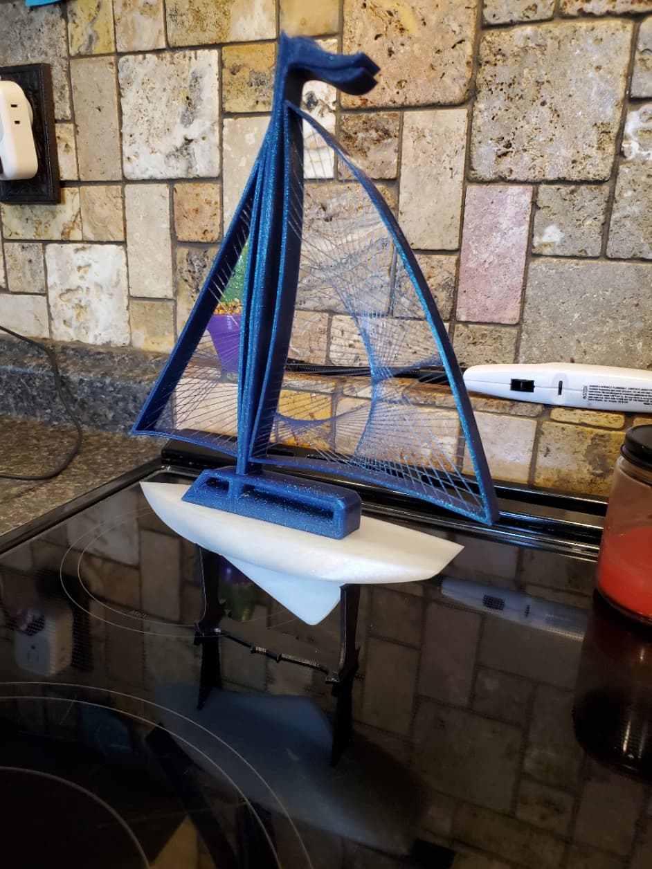 Amolen PLA color changing blue/purple for sails, Solutech PLA clear for hull and Creality black PLA for base. Printed on an Ender 3 Max.