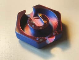 PLA Silk Dual Color (bambulab) with holographic effect on both sides. I cut the model to get bottom and top surface onto the buildplate. Added some pins to perfectly align them after printing. The print also uses variable layer heights to get the smoothest possible curves. 3d model