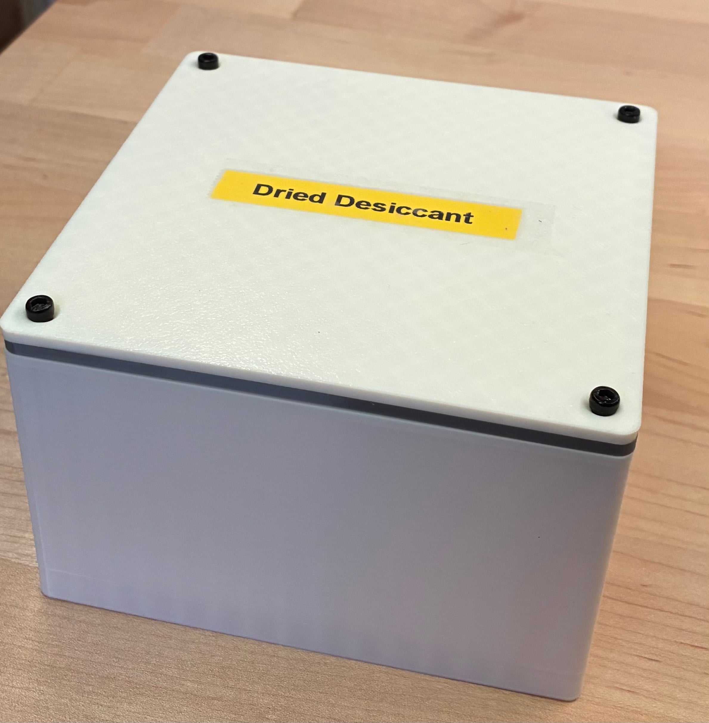 I scaled up this design in my slicer to 120x120x70 mm and increased the thickness of the TPU gasket to 3 mm.
It perfectly fits 4 canisters of Slice Engineering's activated alumina desiccant for long-term storage after recharging in the oven as directed for 2 hours.