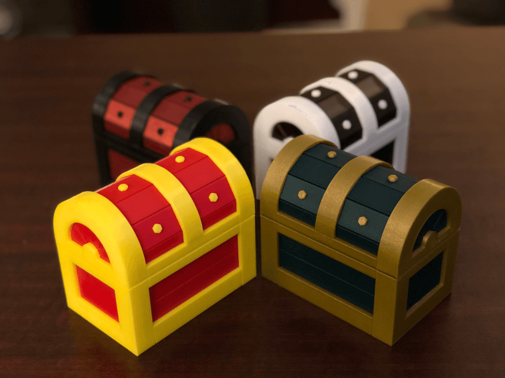 Treasure Chest Puzzle Box - 4 Treasure Chest Puzzle Box prints in different color schemes.
**Black and Red Chest**
Inland PETG (Black)
Prusament PETG (Carmine Red)
**White and Brown Chest**
Inland PETG (White)
Prusament PLA (Mystic Brown)
**Gold and Green Chest**
Fillamentum PLA (Gold Happens)
Prusament PLA (Opal Green)
**Yellow and Red Chest**
Inland PLA (Red)
Inland PLA (Yellow) - 3d model