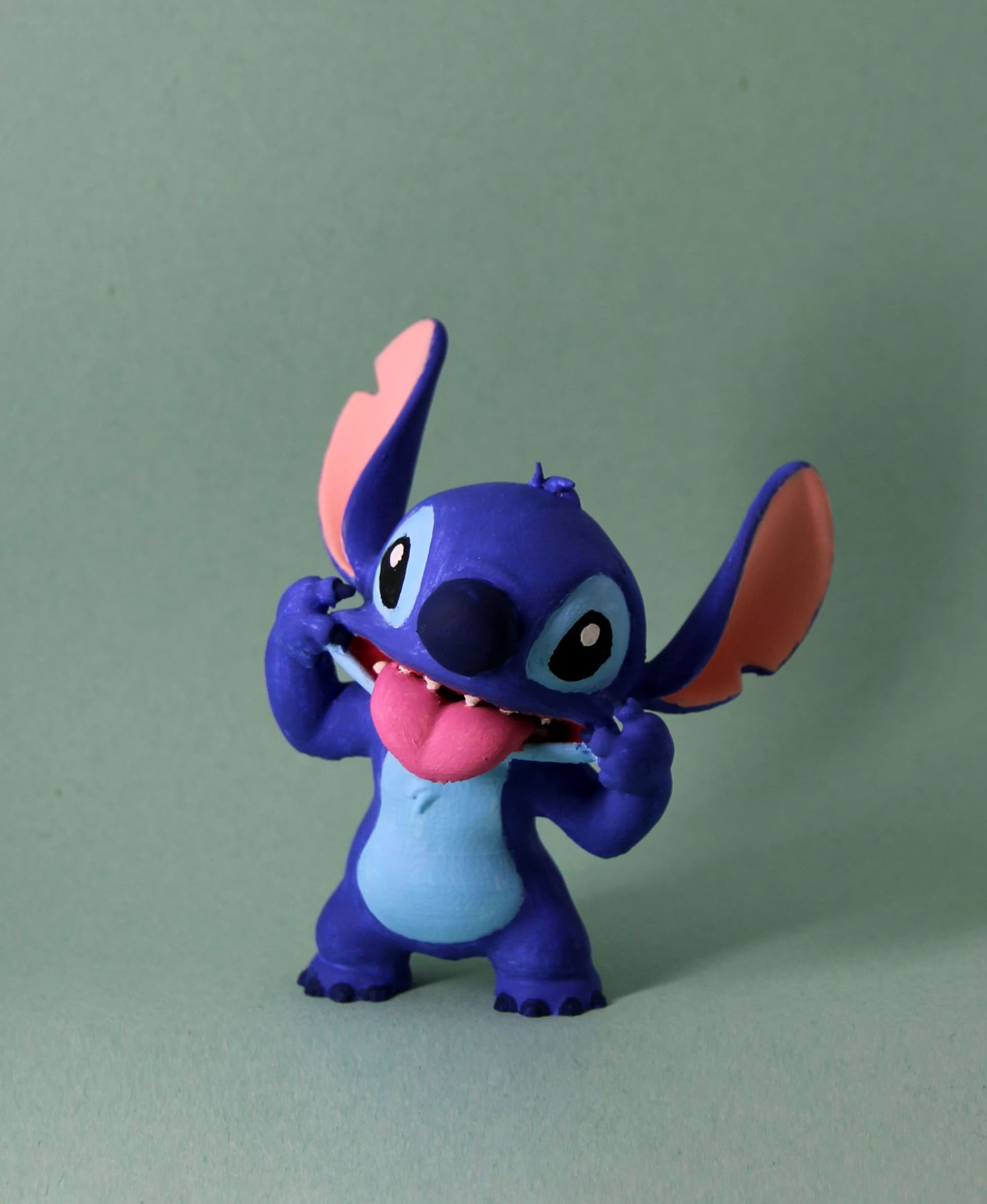 Hand painted Stitch. Recommend Prusa slicer for this, Cura lost an arm due to bad supports.