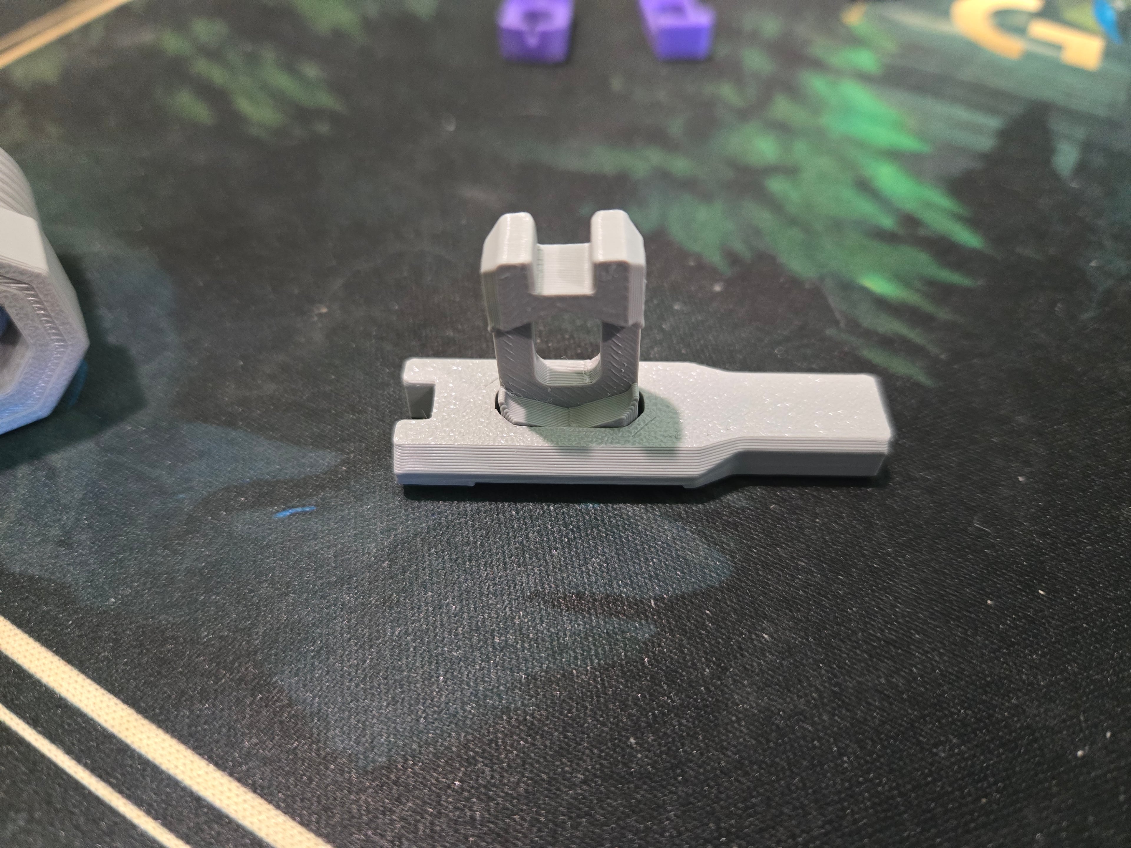 The slots in the tools are to use them as drivers for each other. The hooks/teeth fit small thread T bolts. The smaller tool's non-hook end fits inside push-fit bolts and mid-thread thread-in snaps; with the large tool attached you can use this to tighten these kinds of parts.