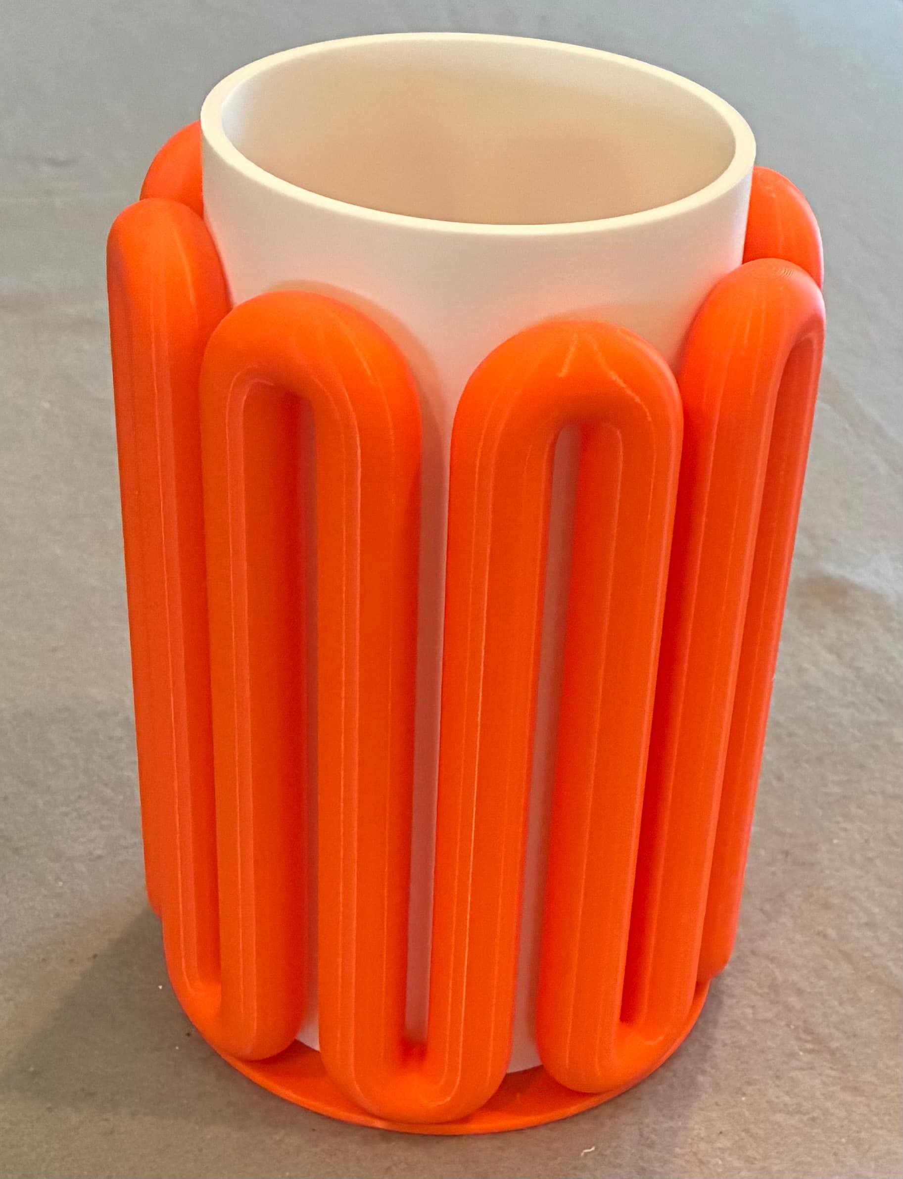 An attractive and fanciful design printed in orange and matte white PLA. Worth the 22 hours to print both parts.