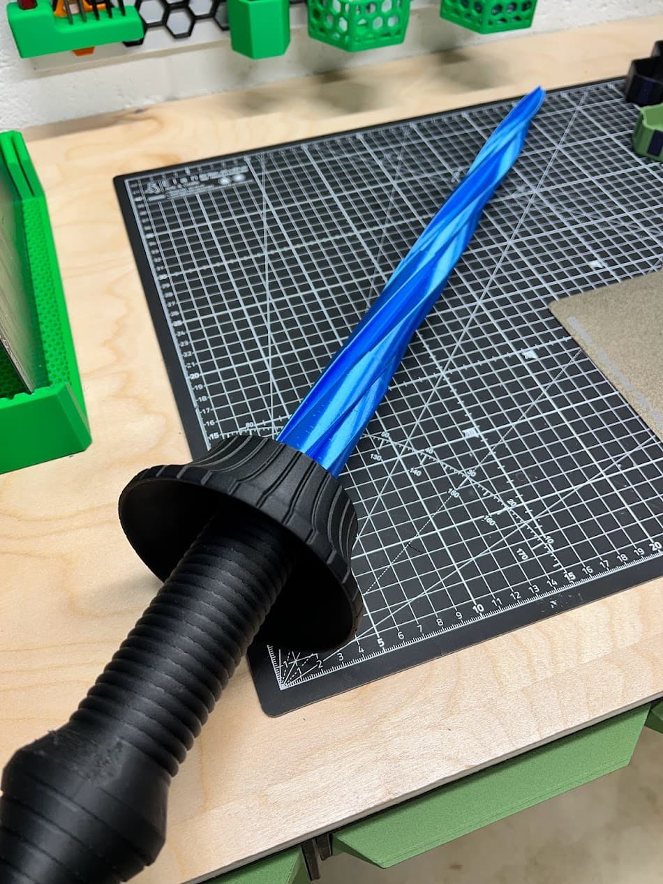 PETG-CF for the hilt and BambuLab blue silk for the blade.