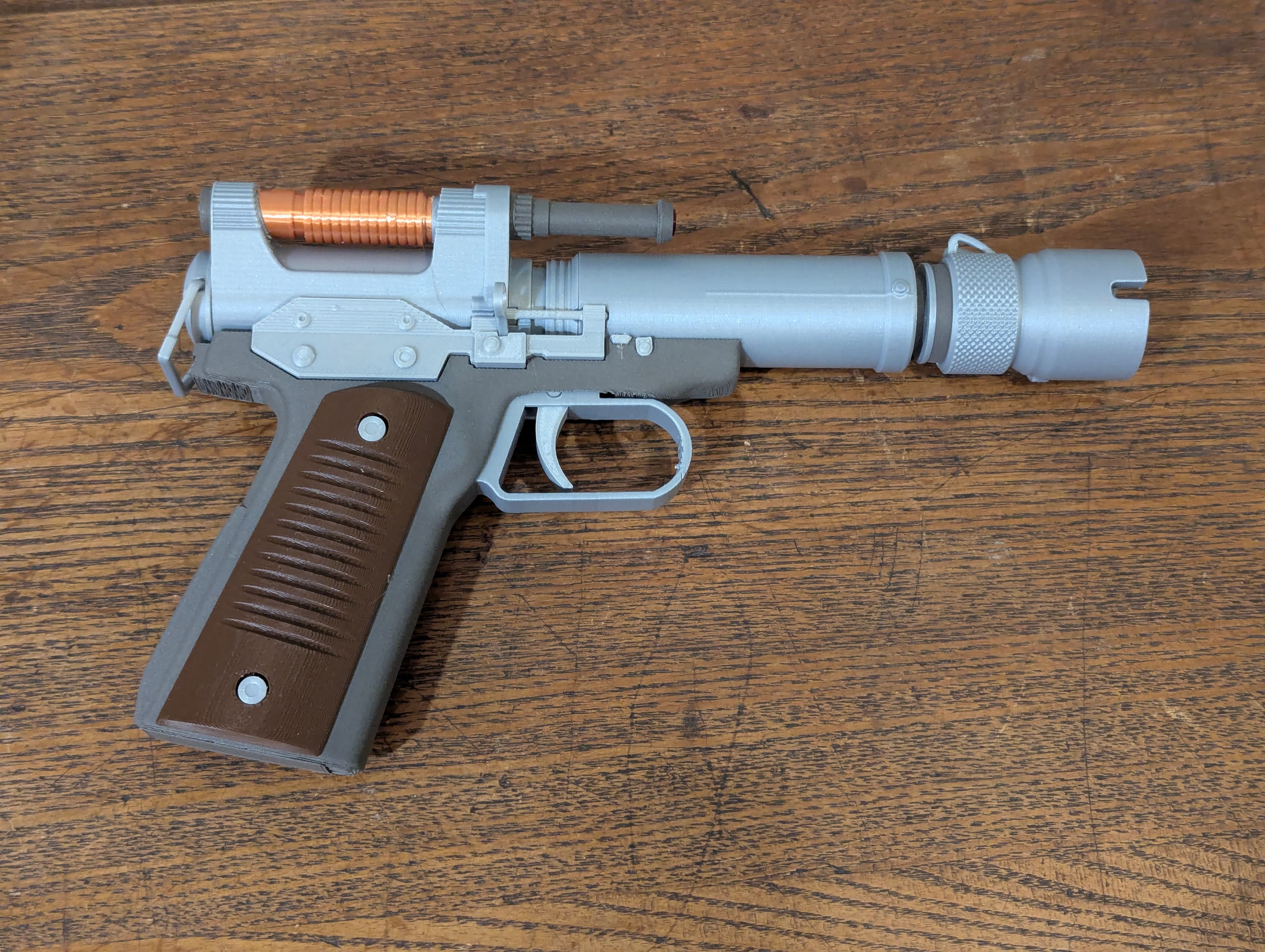 I really wanted to print this blaster. I decided on this version.
I used Polymaker Metallic Silver, Printed Solid Jessie Tree Brown, Sliceworx Silk Copper, and Proto Pasta Composite Steel on Prusa MK3.5.
The 3mf seems to be Bambu Slicer formatted. OrcaSlicer opens it ok, but gives warning of X1C settings. Most of the stl files are not properly oriented for optimal printing.
I split part B2_A so I could print the coil in copper.
I feel as though parts B11 and B10 don't fit properly. The 3mf and stl files seem the same, so not sure why they don't quite fit along B14 on that side.
Spring makes a fun addition.