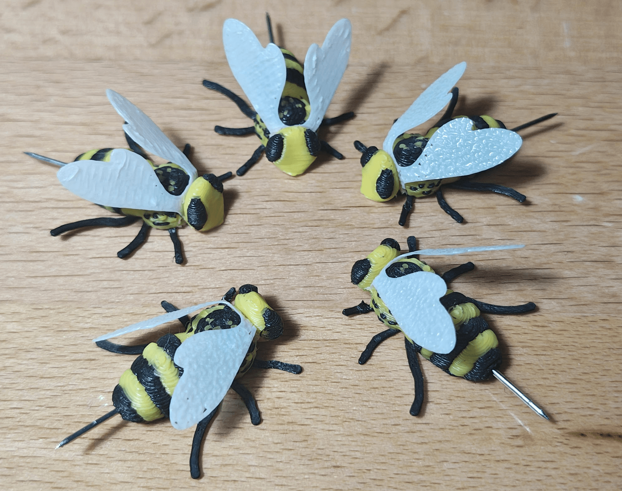 These are cute! The bees really require your printer to be tuned in! I found I had to tilt the heads up to break the connection between the neck and the body before I could push them in. I modified the wings to only be 1 layer thick and used a soldering iron to weld them to the body.