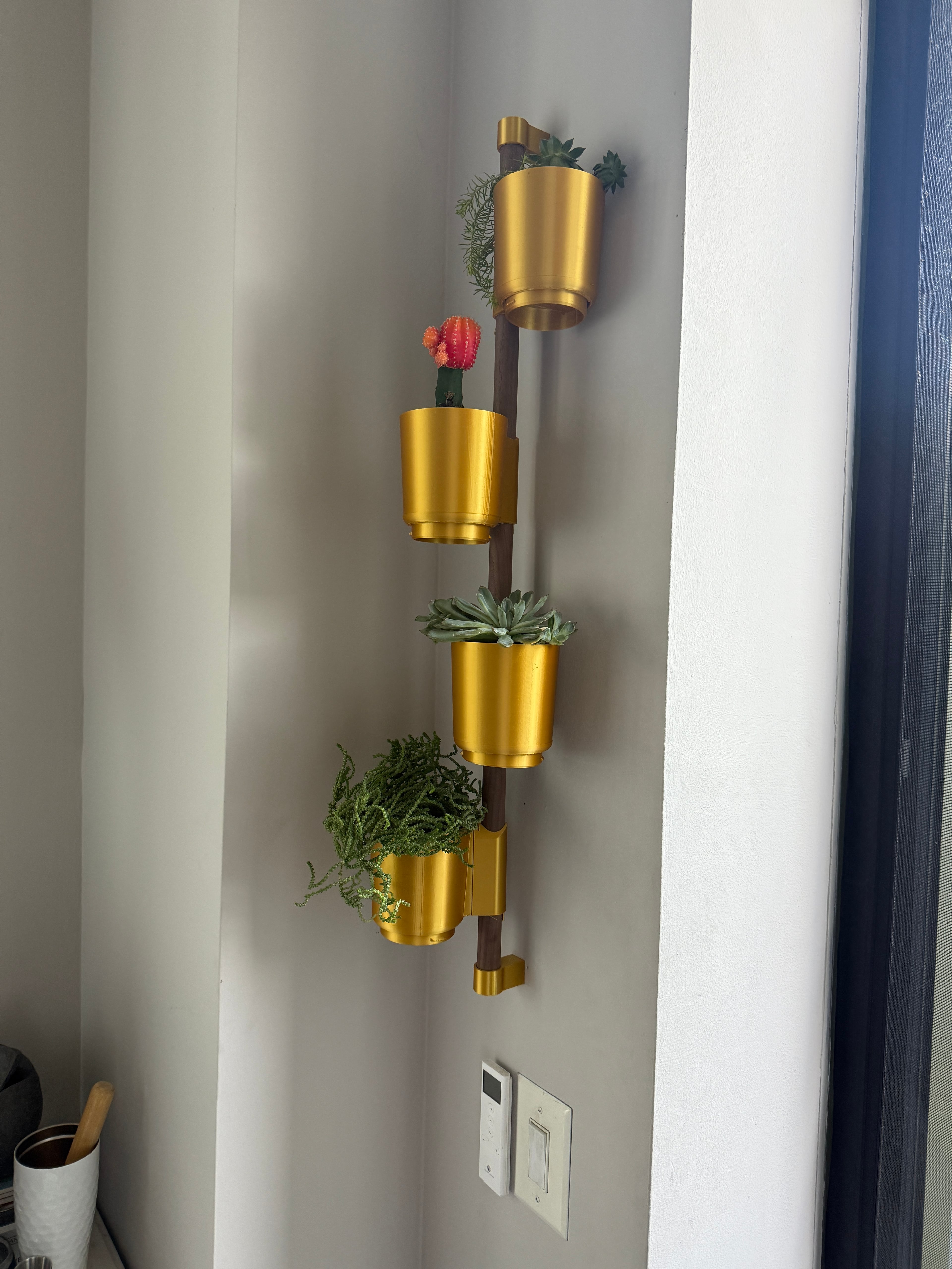 Our printer wasn't big enough to handle the large pot so we used four small. The drip trays for the pots don't fit very well, but I'm using succulents so don't really anticipate a lot of reason to have to be able to pull them out but they sit in their fine. They're just not smooth and they didn't lock in. We used gold simply because my kid had leftover gold filament from printing a crown for Halloween. Thought the walnut dowel would look nice with the gold and I like how it came out.