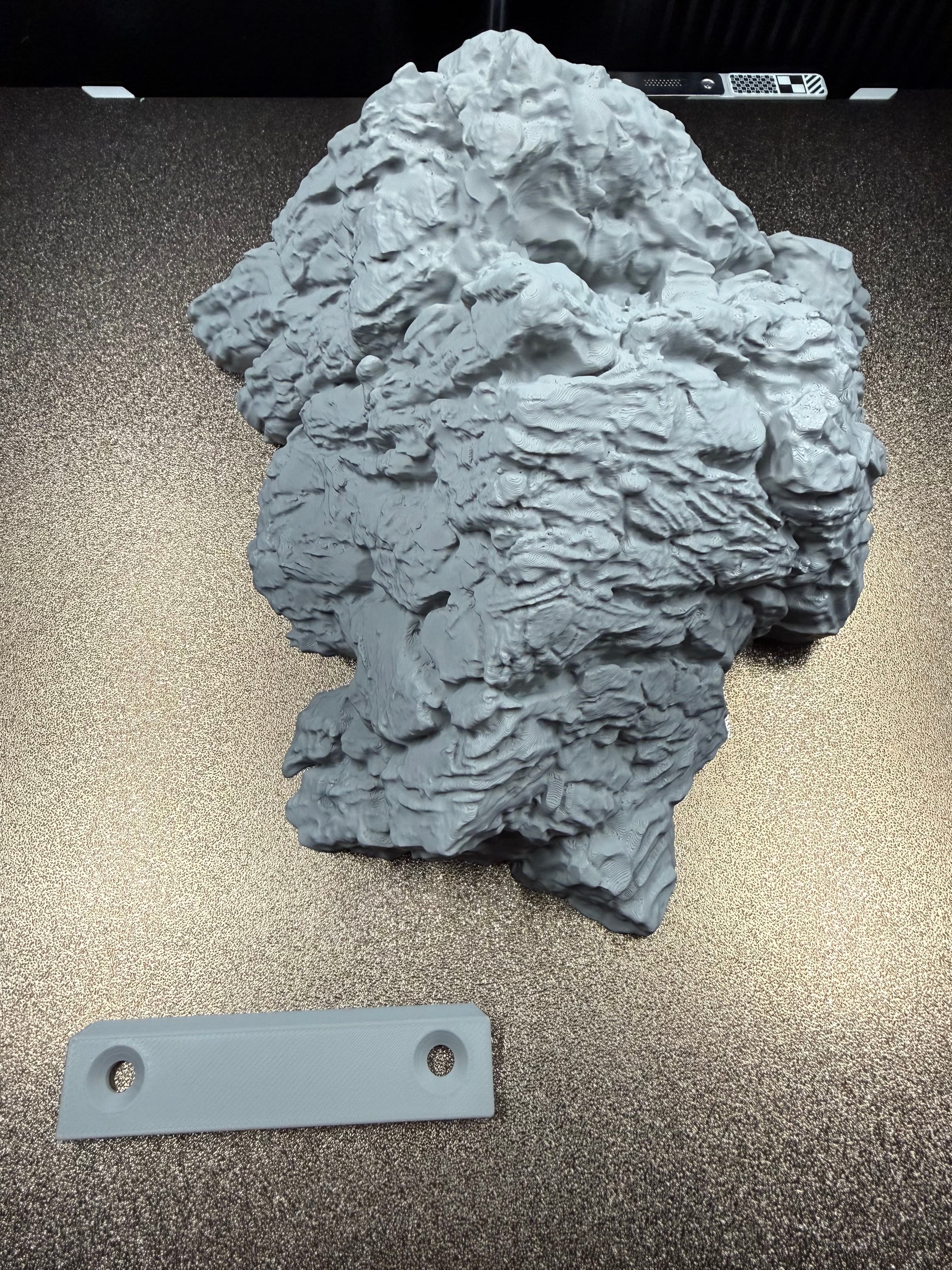 Awesome design, simple to print, I watched the first layer adherence at normal speed, then set to sport mode (124% of normal print speed) to try and introduce natural rock anomalies. The mounting bracket cutout printed nicely, even with no support underneath that fairly large section.