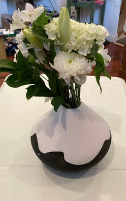 A lovely result after 42 hours printing. The flowers are real and not 3-D printed(!). The top half warped a bit at the transition between the supports and the first "real" layer for the design. 3d model