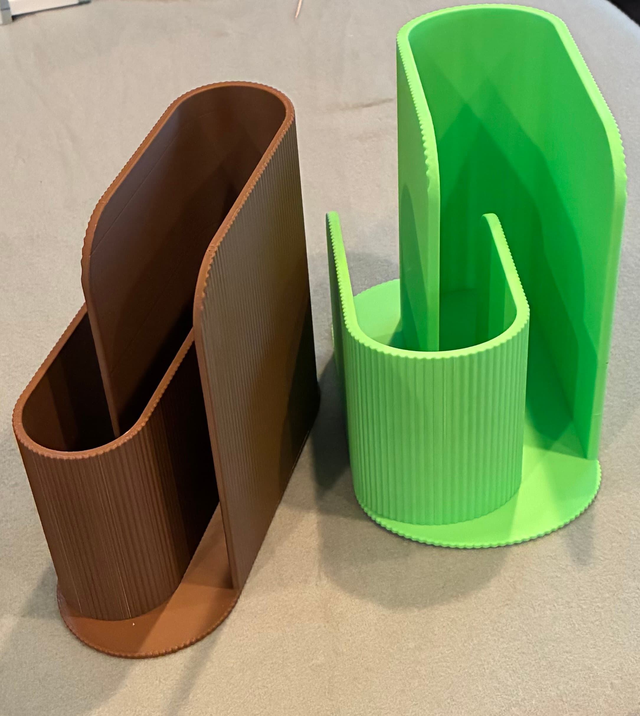 The original design printed well (brown) but the slots were too narrow for the folded notebook I have. I scaled the X-axis to make the design wider (green) and my unit now fits.