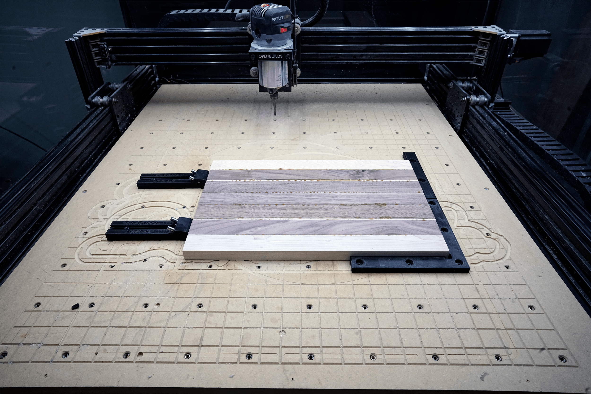 Low Profile Toe Clamp for CNC Router (Heat-Set Insert Version) - This cutting board if firmly held by two toe clamps pressing the board into the right-angle jig. The entire top of the cutting board can be faced/carved without running over a clamp. - 3d model