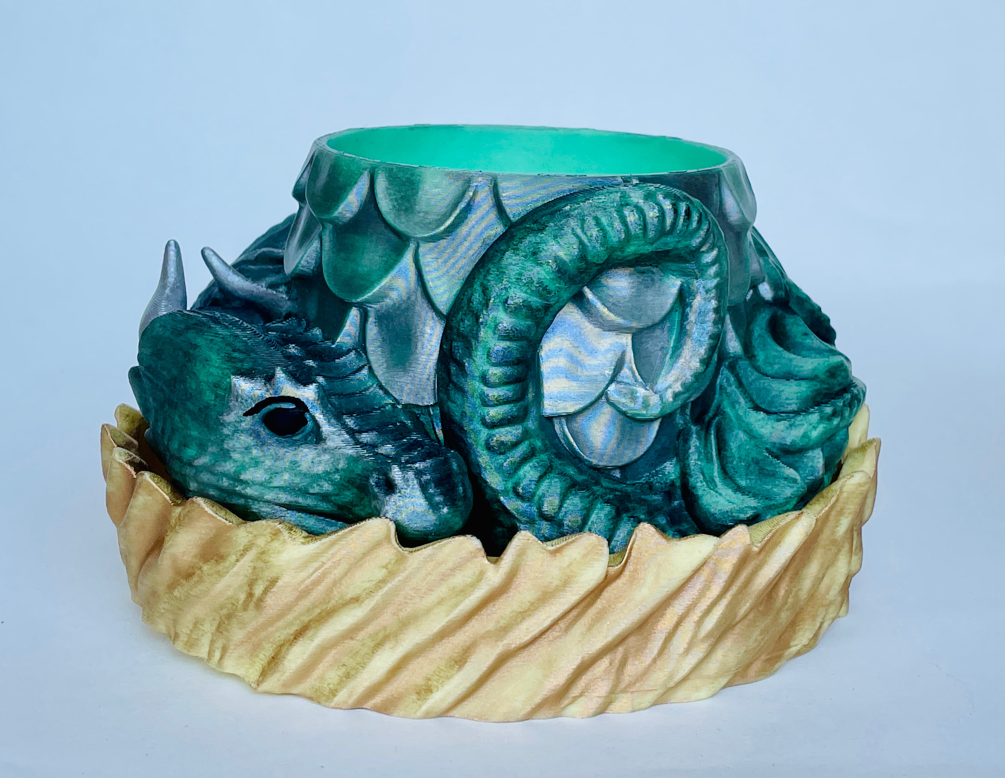 Very cute. Printed easily. No supports required. The drainage is well designed.
My one edit request would be to lower the height of the "nest" or raise the inserts so the dragon is more visible.
Painted with Rub'n Buff.